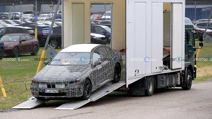 bmw-i5-spy-shots-coming-off-truck