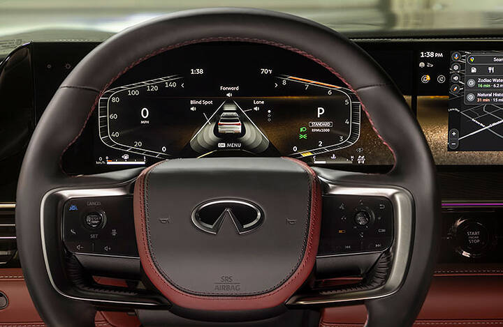 Close-up of the steering wheel and speedometer window in the 2025 INFINITI QX80.