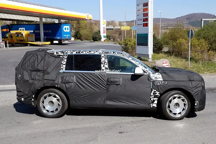 2026-genesis-gv90-electric-flagship-suv-spied-charging-looks-massive_11