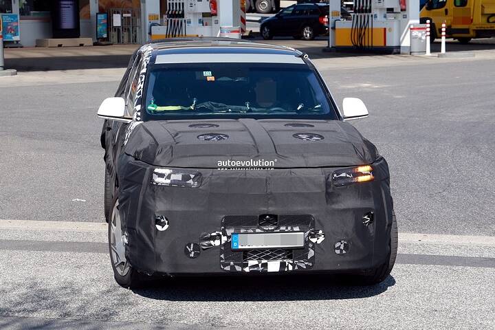 2026-genesis-gv90-electric-flagship-suv-spied-charging-looks-massive_5