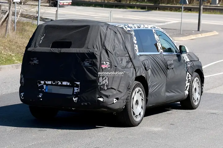 2026-genesis-gv90-electric-flagship-suv-spied-charging-looks-massive_17