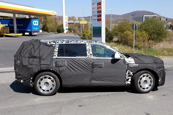 2026-genesis-gv90-electric-flagship-suv-spied-charging-looks-massive_12